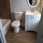 A small bathroom with a toilet, sink, and bathtub.